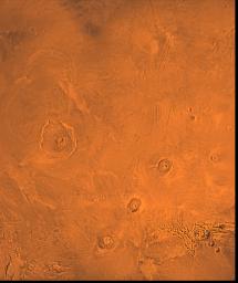 The Tharsis region of Mars; north toward top. This scene shows the Tharsis bulge, a huge ridge covered by the 3 large aligned Tharsis Montes shield volcanoes (from lower l to r): Arsia, Pavonis, and Ascraeus Mons as seen by NASA's Viking spacecraft.