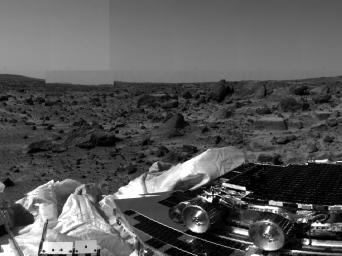NASAs undeployed Sojourner rover is seen still latched to a lander petal in this image, taken on July 4, 1997, the lander's first day on Mars. Portions of a petal and deflated airbag are in the foreground.