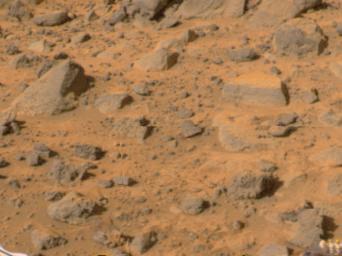 'Flat Top,' the rectangular rock at right, is part of a stretch of rocky terrain in this image, taken by NASA's deployed Imager for Mars Pathfinder (IMP) on July 7, 1997. The rock dubbed 'Wedge' is at left. 