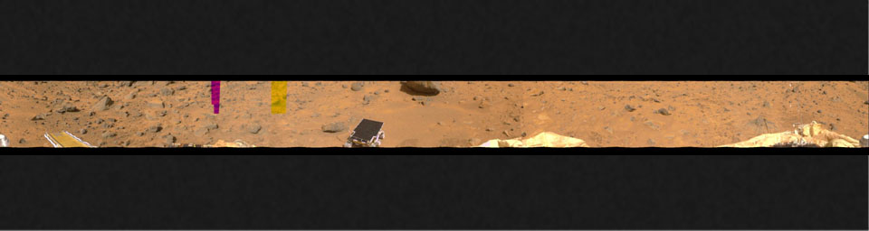 This image represents the first two tiers of a 360-degree color panorama, taken by NASA's Imager for Mars Pathfinder (IMP) on July 9, 1997. At left, the forward ramp is visible near the larger rocks.