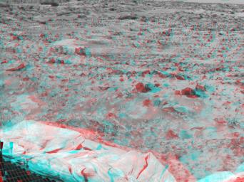 Portions of the lander's deflated airbags and a petal are at lower left in this image from NASA's Mars Pathfinder. 3D glasses are necessary to identify surface detail. 
