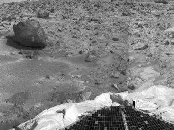 The left portion of this image, taken by NASA's Imager for Mars Pathfinder (IMP) on July 7, 1997, shows the large rock nicknamed 'Yogi.' Portions of a petal and deflated airbag are in the foreground.