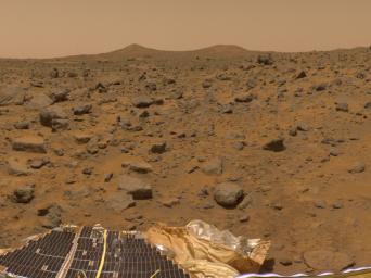 The prominent hills dubbed 'Twin Peaks' were imaged by NASA's Imager for Mars Pathfinder (IMP) as part of a 360-degree color panorama, taken Jul. 13-14, 1997. A lander petal and deflated airbag are at the bottom of the image.