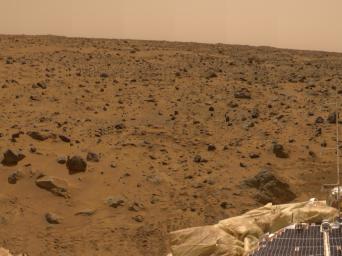 This view from the lander was imaged by NASA's Imager for Mars Pathfinder (IMP) as part of a 360-degree color panorama, taken over sols 8, 9 and 10. A deflated airbag is at the bottom of the image. Sol 1 began on July 4, 1997.