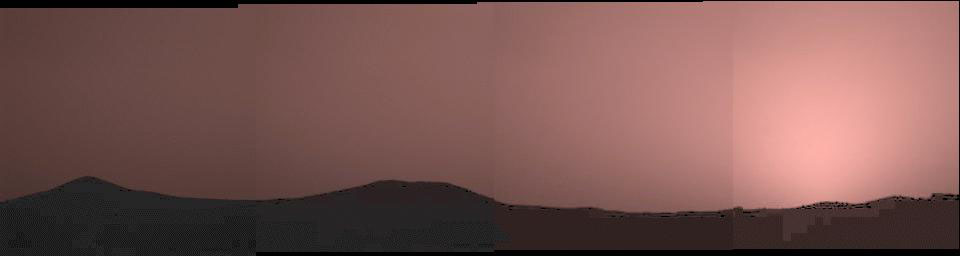 This image was taken by the Imager for NASA's Mars Pathfinder about one minute after sunset on Mars on Sol 21. The prominent hills dubbed 'Twin Peaks' form a dark silhouette at the horizon, while the setting sun casts a pink glow over the darkening sky.