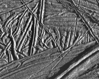 This high resolution image of the icy crust of Europa, one of Jupiter's moons, reveals a surface criss-crossed by multiple sets of ridges and fractures. This image was taken by NASA's Galileo spacecraft on February 20, 1997.