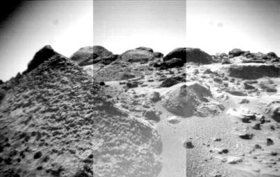 The front cameras aboard NASA's rover Sojourner imaged several prominent rocks on Sol 44. The highly-textured rock at left is Wedge, and in the background from left to right are 'Shark,' 'Half-Dome,' and 'Moe.' Sol 1 began on July 4, 1997.