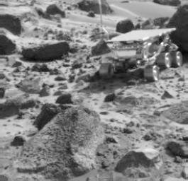 NASA's Imager for Mars Pathfinder (IMP) image taken near the end of daytime operations on Sol 50 shows the Sojourner rover between the rocks 'Wedge' (foreground) and 'Shark' (behind rover). Sol 1 began on July 4, 1997.