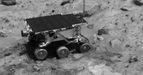 NASA's Imager for Mars Pathfinder (IMP) caught this image of the rover as it was digging in the 'compressible' material near the rock Casper to determine the soil's mechanical properties on Sol 23. Sol 1 began on July 4, 1997.