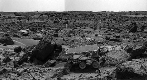 NASA's Sojourner rover's Alpha Proton X-ray Spectrometer (APXS) is shown deployed against the rock 'Moe' on the afternoon of Sol 64 (September 7, 1977). The rocks to the left of Moe are 'Shark' (left of Sojourner) and 'Half Dome' (behind Sojourner). 