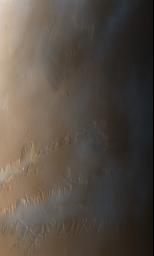 This image from NASA's Mars Global Surveyor taken on Oct. 3, 1997, shows late afternoon clouds and hazes that are concentrated within the Valles Marineris canyon system.