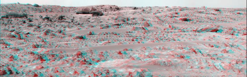 The large, elongated rock left of center in the middle distance is 'Zaphod' is seen in this image from NASA's Mars Pathfinder. 3D glasses are necessary to identify surface detail. 