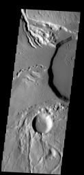 This image shows part of the summit caldera of Ceraunius Tholus on Mars. Channels are common on the flanks of this volcano on Mars, taken by NASA's Mars 2001 Odyssey spacecraft.