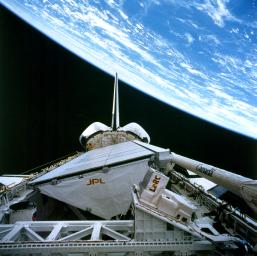 NASA's SIR-C/X-SAR is shown here in the payload bay of the orbiting space shuttle Endeavour (STS-59), with an area of the Pacific Ocean northeast of Hawaii in the background. 