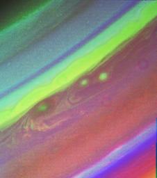 This false color picture of Saturn's northern hemisphere was assembled from ultraviolet, violet and green images obtained Aug. 19, 1998 by NASA's Voyager 2. The several weather patterns evident include three spots flowing westward.