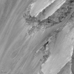 NASA's Mars Global Surveyor acquired this image on Jan 6, 1998. Shown here are layered materials in the walls and on the floors of the enormous Valles Marineris system.