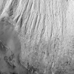 NASA's Mars Global Surveyor acquired this image on April 20, 1998. Shown here are layered materials in the walls and on the floors of the enormous Valles Marineris system.