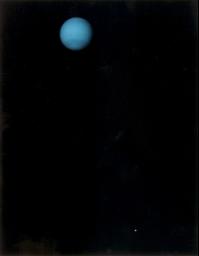 This image was returned by NASA's Voyager 2 spacecraft on July 3, 1989. The planet and its largest satellite, Triton, are captured in view; Triton appears in the lower right corner at about 5 o'clock relative to Neptune.
