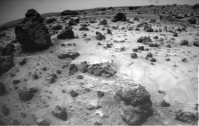 NASA's Mars Pathfinder's rover Sojourner imaged this area of Martian terrain on Sol 26, 1997. The large rock dubbed 'Pooh Bear' is at far left. 'Mermaid Dune' is the smooth area stretching horizontally across the top quarter of the image.