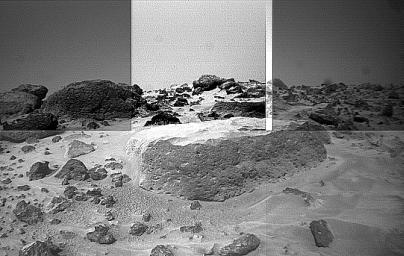 This image of the rock 'Flat Top' was taken from the left of NASA's Sojourner rover's front cameras on Sol 42. Pits on the edge of the rock and a fluted surface are clearly visible. The rocks in the left background comprise the Rock Garden.
