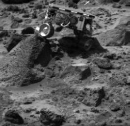Sojourner's left rear wheel is perched on the rock 'Wedge' in this image, taken on Sol 47 by the Imager for NASA's Mars Pathfinder (IMP).