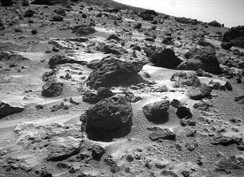 This left image of a stereo image pair, taken on Sol 72 (September 15) from NASA's Sojourner rover's front cameras, shows areas of the Pathfinder landing site never before seen. The large rock on the right is 'Chimp.' Sol 1 began on July 4, 1997.