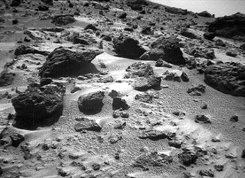 This right image of a stereo image pair, taken on Sol 72 (September 15) from NASA's Sojourner rover's front cameras, shows areas of the Pathfinder landing site never before seen. The large rock on the right is 'Chimp.' Sol 1 began on July 4, 1997.