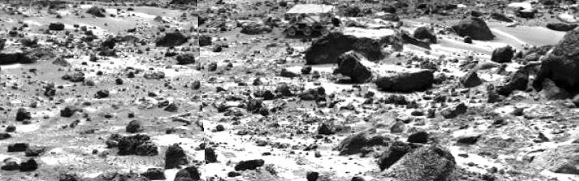 This right image of a stereo image pair taken on the afternoon of Sol 74 (September 17) shows NASA's Sojourner rover behind the rock 'Chimp.' Sojourner is now a record 12.3 m from the lander. Sol 1 began on July 4, 1997.