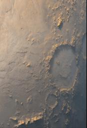 This image was captured by NASA's Mars Global Surveyor during March 1999 showing Galle Crater smiling back at the camera from its location on the east side of Argyre Planitia on Mars. The bluish-white tone is caused by wintertime frost.