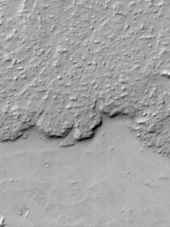 NASA's Mars Global Surveyor shows the margin of a large lava flow located on Daedalia Planum, southwest of the Arsia Mons volcano. The lava flow surface is rough but mantled with fine sand or dust. 