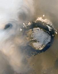 NASA's Mars Global Surveyor shows two annular clouds, common in mid-northern summer in the north polar region on Mars, and may result from eddy currents in the lower atmosphere.