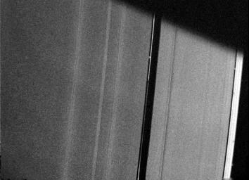 NASA's Voyager 2 acquired this photograph of Saturn's A-ring Aug. 26, 1981, from a distance of 227,800 kilometers (141,500 miles). This view of the ring's outer edge shows a small bright, clumpy ring within the Encke Gap.