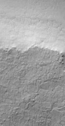 NASA's Mars Global Surveyor shows a polygonally-patterned surface on southern Malea Planum on Mars. The surface appears a relatively uniform gray. At the time the picture was acquired, the surface was covered with south polar wintertime frost.