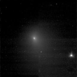 This image shows comet Tempel 1 as seen by NASA's Deep Impact spacecraft on June 20, 2005. The object on the right is a star.