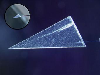 This image illustrates one of several ways scientists have begun extracting comet particles from NASA'a Stardust spacecraft's collector. First, a particle and its track are cut out of the collector material, called aerogel.