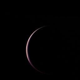 NASA's Voyager 2 obtained this parting shot of Triton, Neptune's largest satellite, shortly after closest approach to the moon and passage through its shadow on the morning of Aug. 25, 1989.