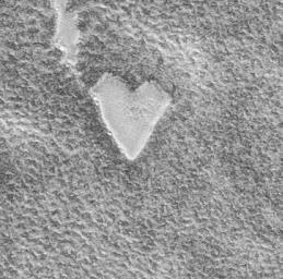 NASA's Mars Global Surveyor captured this unique view of a bright, heart-shaped mesa in the south polar region on November 26, 1999.