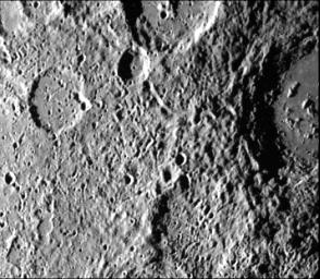 Cratered terrain very similar to that on the Moon is shown in this TV photo of Mercury taken by NASA's Mariner 10. Numerous small craters and linear grooves radial to the crater can be seen.
