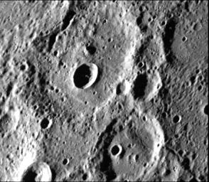 A fresh new crater in the center of an older crater basin is shown in this picture of the surface of Mercury taken March 29, 1974 by NASA's Mariner 10.