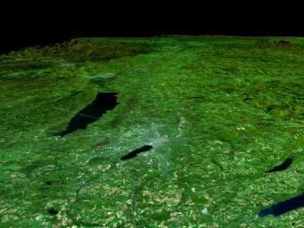 In the lower center of this view from NASA's Shuttle Radar Topography Mission of upstate New York, the city of Syracuse hugs the southeastern banks (top right side) of Lake Onondaga, the smaller of the two dark features that dominate the scene.