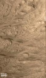 NASA's Mars Global Surveyor shows layered material in west Arabia Terra crater on Mars.

