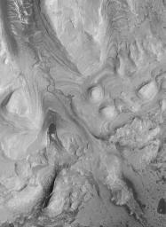 NASA's Mars Global Surveyor shows southwestern Candor Chasma on Mars. The most striking feature is the filled channel.
