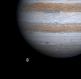 The solar system's largest moon, Ganymede, is captured here alongside the planet Jupiter in a color picture taken by NASA's Cassini spacecraft on Dec. 3, 2000.