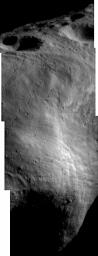 This image of asteroid Eros, taken by NASA's NEAR Shoemaker on April 13, 2000, shows large craters in the north polar region; part of the ridge that wraps one-third of the way around Eros; western part of the saddle; a dense field of enormous boulders.