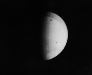 The most conspicuous feature yet observed on Mars by NASA's Mariner 9 in 1971 is the darkish spot located near the top of this picture. It had been tentatively identified as Nix Olympica.