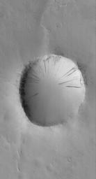 NASA's Mars Global Surveyor shows an old impact crater in southeastern Arabia Terra on Mars. The crater ejecta blanket is no longer visible and all of the terrain has been covered by a mantle of dust. 