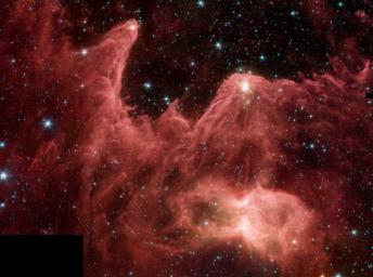 This majestic false-color image from NASA's Spitzer Space Telescope shows 'mountains' where stars are born. These towering pillars of cool gas and dust are illuminated at their tips with light from warm embryonic stars. 