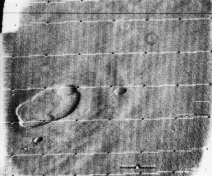 This is an oblique view of the crater complex near Ascraeus Lacus in the Tharsis region of Mars was taken by NASA's Mariner 9 in 1971. The spot consists of several intersecting shallow crater-like depressions.