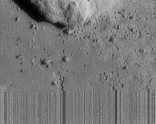This image of asteroid 433 Eros, was the last received from NASA's NEAR Shoemaker. Streaky lines at the bottom indicate loss of signal as the spacecraft touched down on the asteroid during transmission of this image.