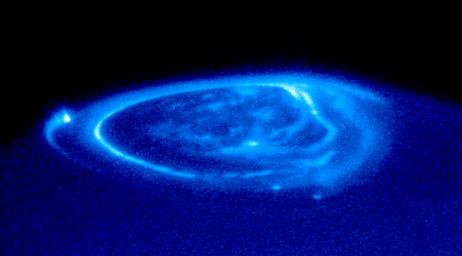 This is a spectacular NASA Hubble Space Telescope close-up view of an electric-blue aurora that is eerily glowing one half billion miles away on the giant planet Jupiter.